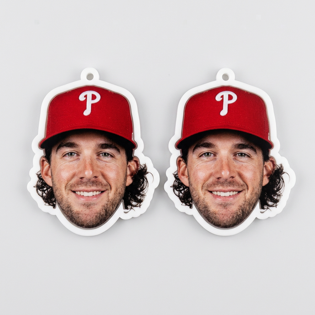 Two paper cutouts of a man wearing a red baseball cap with a 'P' logo on a gray background.