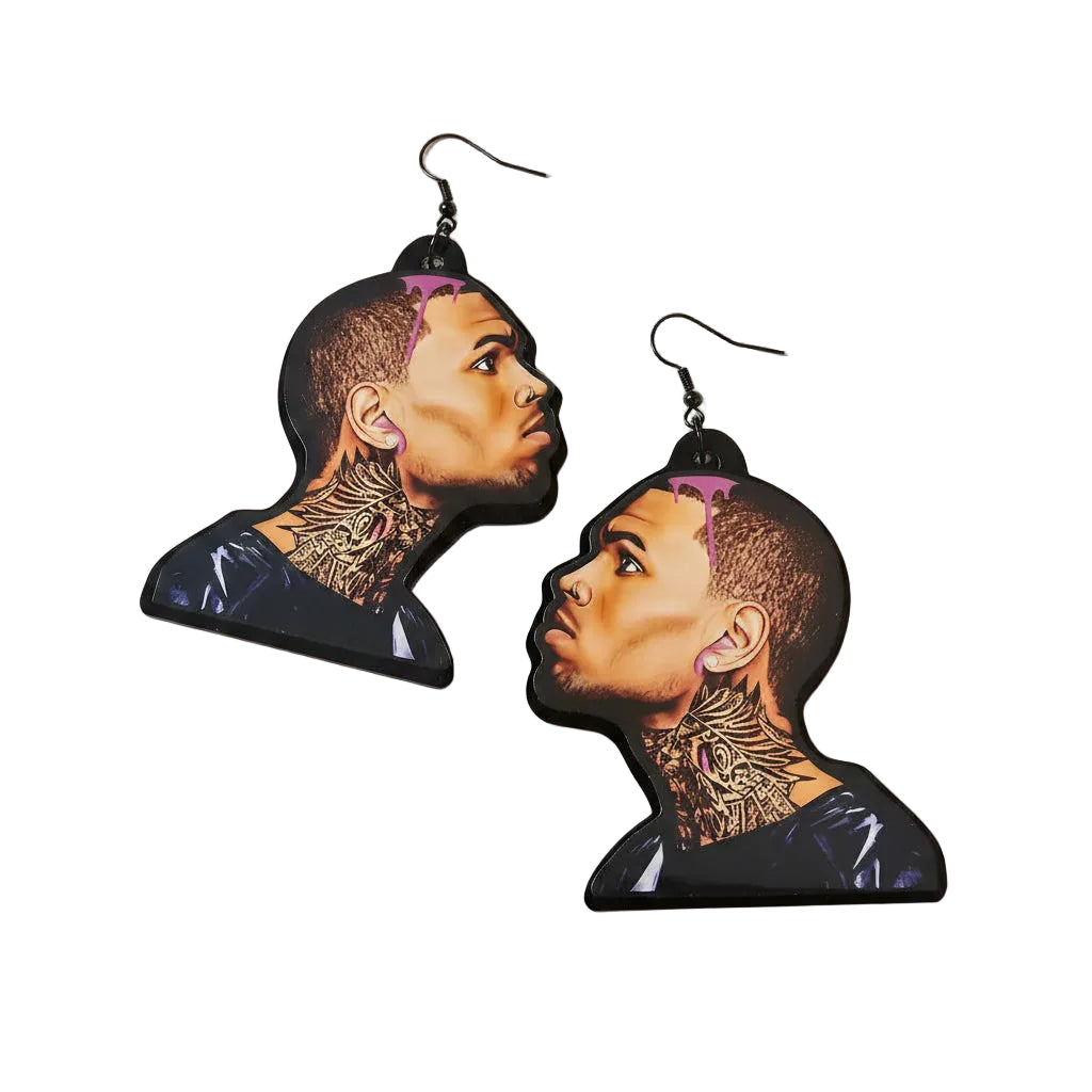 Earrings with a design of a chris brown's face and tattoos on a plain background