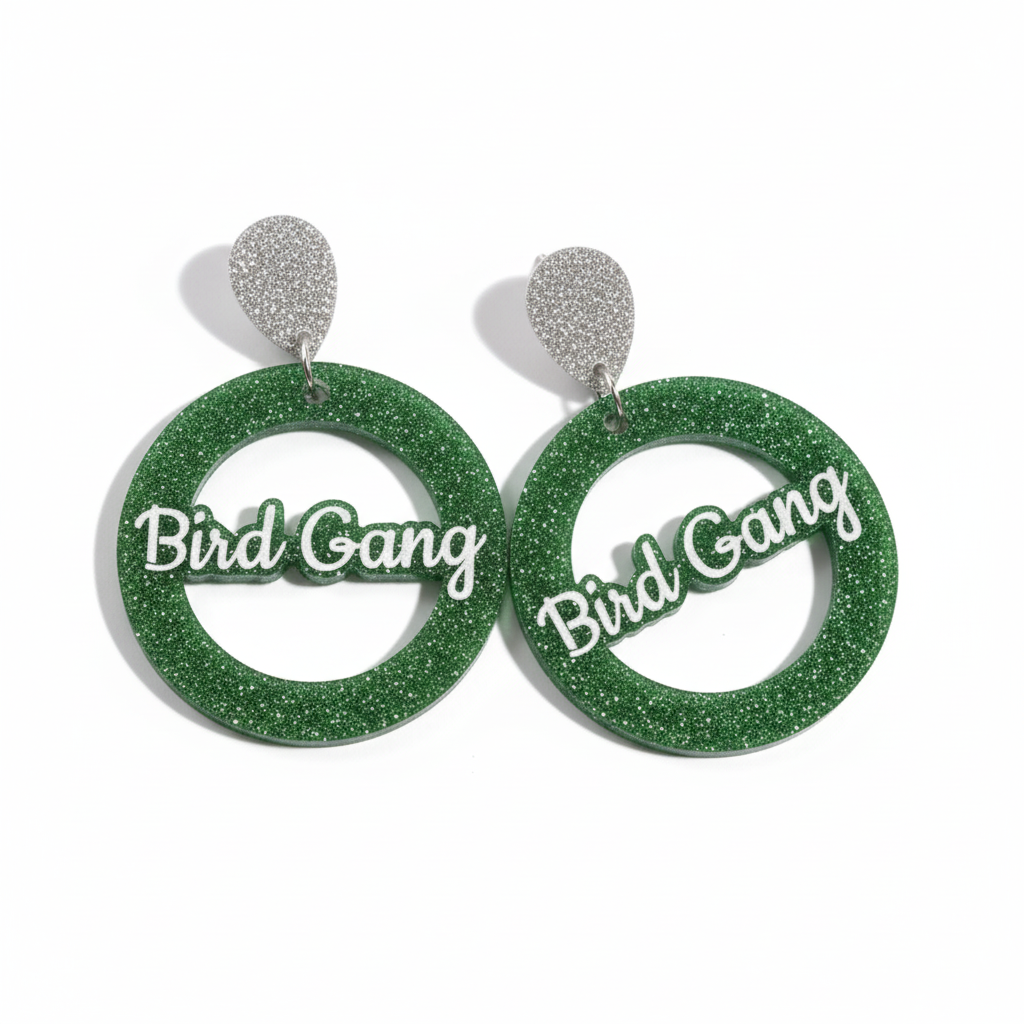 Green glittery earrings with 'Bird Gang' text on a white background