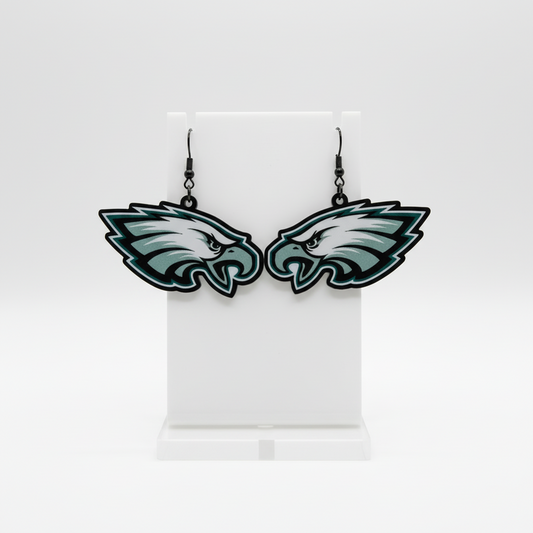 Pair of Eagles logo earrings on a white card with a white background