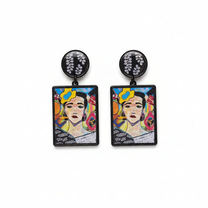 Pair of earrings with colorful designs on a gray surface, branded 'The Earrings Lady'.