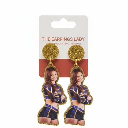 Earrings with a packaging card featuring a person in a uniform, held by a hand.