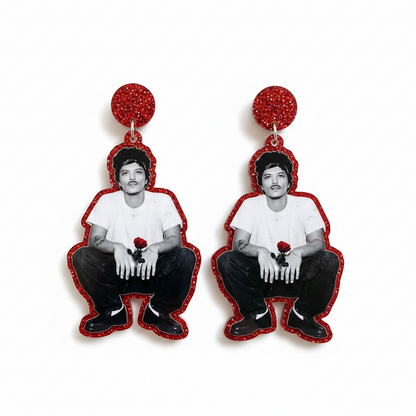 Earrings with burno mars holding a rose on a marble surface