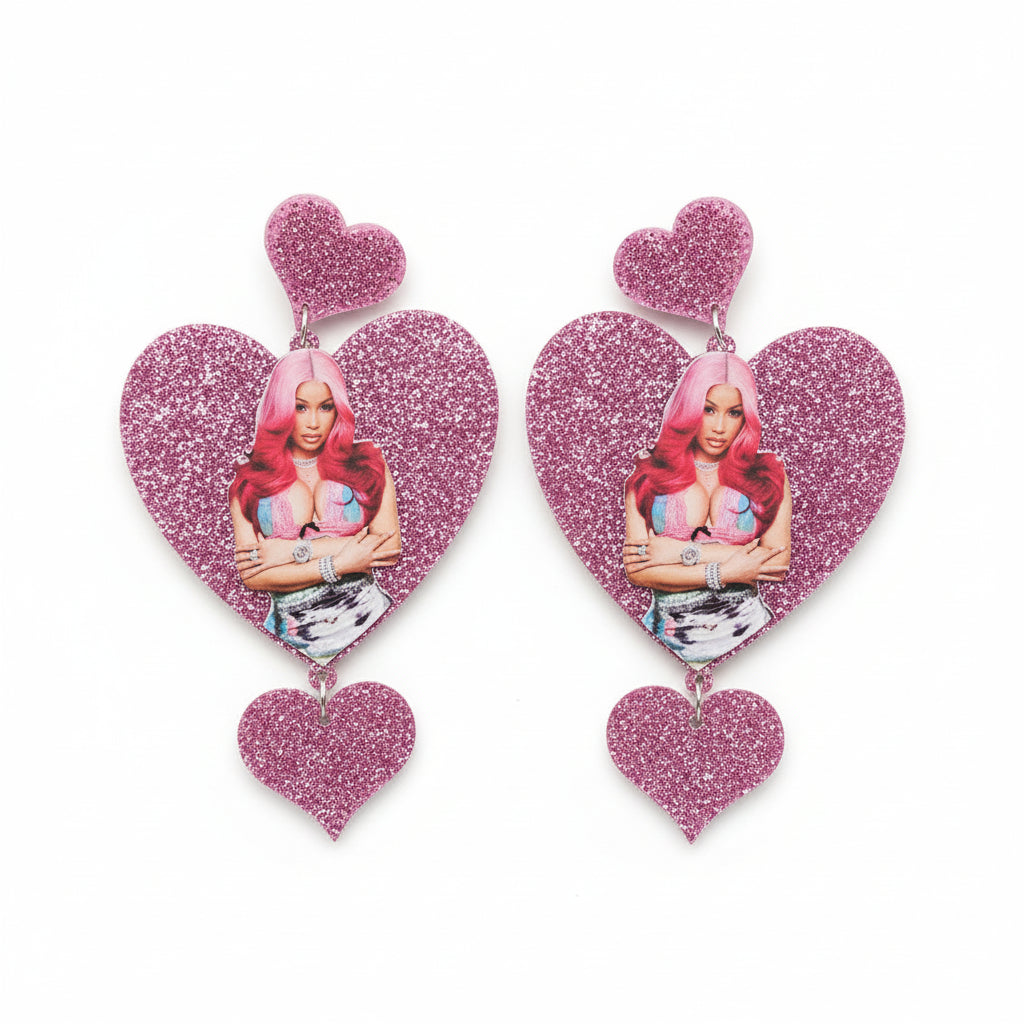 Heart-shaped earrings with a Cardi Bwith pink hair 