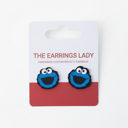 Cookie Monster earrings on a branded card with 'The Earrings Lady' branding.