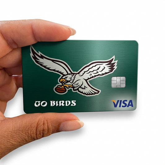 A hand holding a green Philadelphia Eagles themed Visa card with an eagle logo and 'GO BIRDS' text, isolated on a white background.