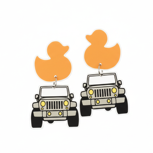 Pair of earrings with duck and jeep designs on a brown card, held by a hand.