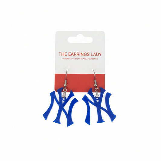 A pair of blue s on a white and red display card from 'The Earrings Lady', photographed on a light gray surface.
