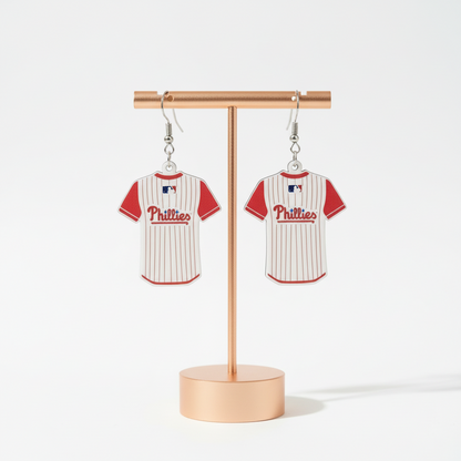 Pair of Philadelphia Phillies baseball jersey earrings on a textured surface