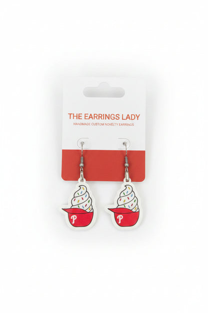 Ice cream cone-shaped earrings on a 'The Earrings Lady' branded card, displayed on a carpeted surface.
