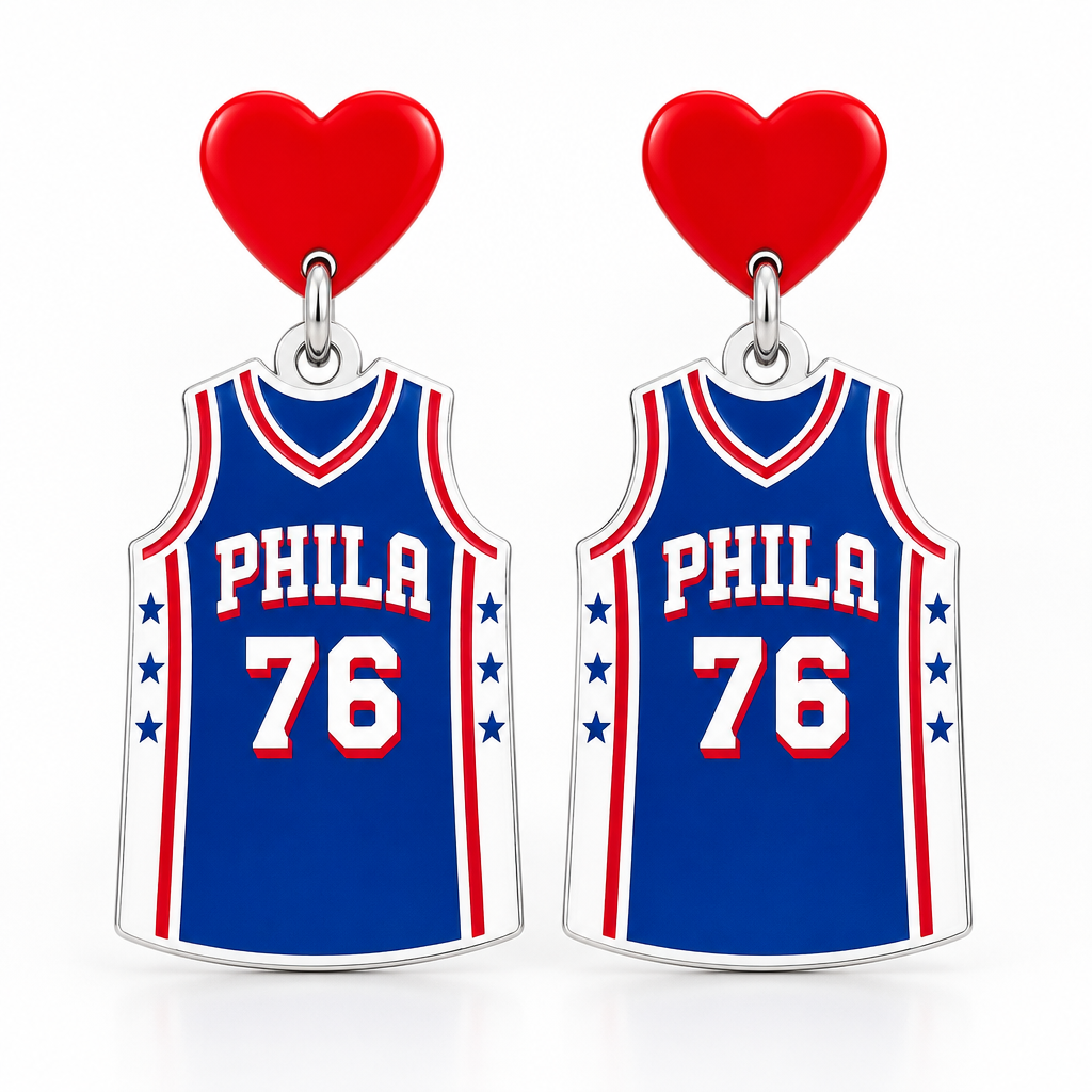 A pair of basketball jersey-shaped earrings or charms featuring the Philadelphia 76ers logo, with blue jerseys, red and white trim, the number 76, and a red heart at the top, shown on a gray background.